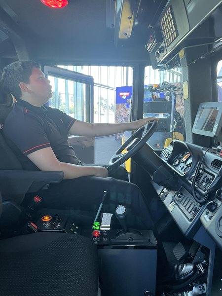 Boy inside sitting inside machine cab