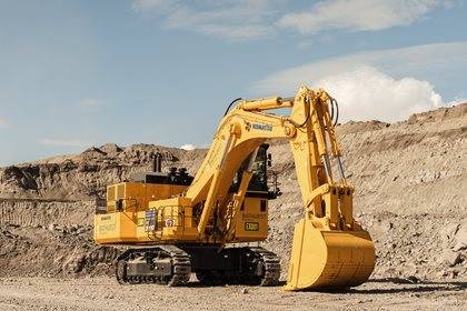 A large yellow Komatsu excavator on a mine site.